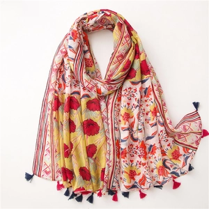 Detail of pink cotton linen scarf with floral totem patterns and tassel edges