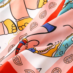 Detail of colorful elephant print scarf showing silky texture and vibrant paisley patterns