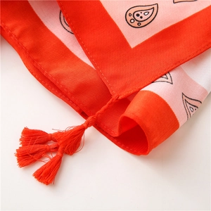 Detailed view of red paisley cotton linen scarf with elegant fringe tassels for beach wear