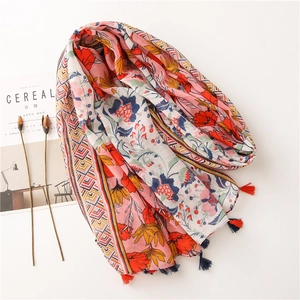 Detailed macro view of ethnic floral cotton linen shawl with vibrant fringe tassels