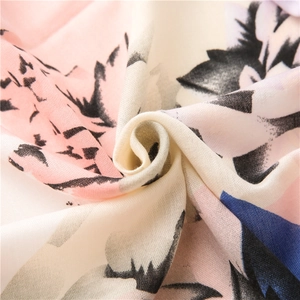 Retro linen-cotton scarf featuring blue and pink floral abstract prints in a spiral fold