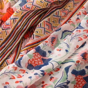 Detailed texture of lightweight cotton-linen scarf with colorful ethnic floral patterns