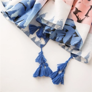 Detailed macro shot of cotton linen scarf with blue and pink print and navy fringe