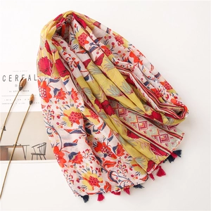 Detail of floral ethnic print cotton linen scarf with colorful tassel fringe edges