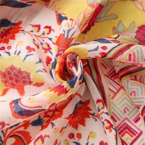 Pink bohemian cotton linen scarf with ethnic floral print shown in a swirl fold design
