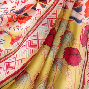 Close-up of pink ethnic totem pattern on breathable cotton linen scarf fabric texture
