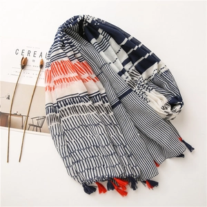 Minimalist cotton linen scarf with blue stripes, orange accents and tassels