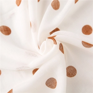 White linen scarf with brown polka dots showing lightweight breathable fabric texture