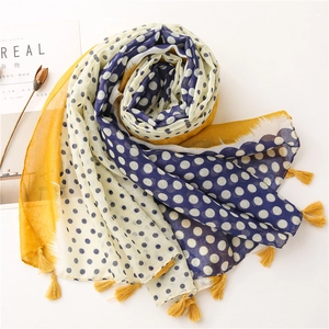 Detailed close-up of polka dot scarf featuring color-block design and yellow tassels