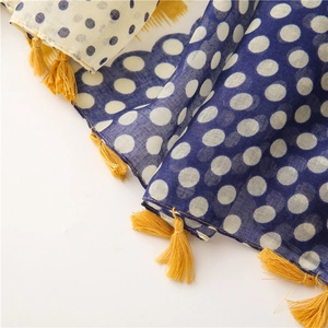 Detail of polka dot cotton linen scarf showing contrasting patterns and yellow fringe