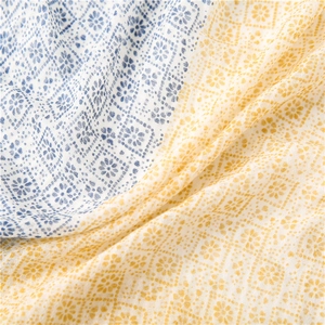 Blue and yellow floral cotton linen scarf featuring geometric patterns and soft textures