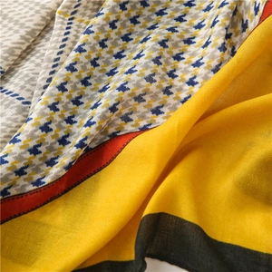 Detailed texture of cotton linen houndstooth scarf with yellow and blue patchwork patterns