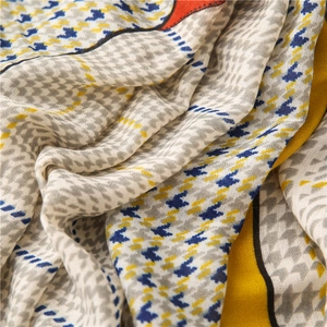 Detail of houndstooth pattern scarf with vibrant blue, yellow and orange color blocking