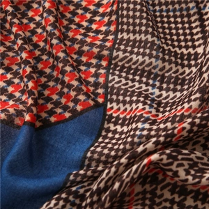 Close-up of houndstooth cotton linen scarf showing red, blue and black woven textures