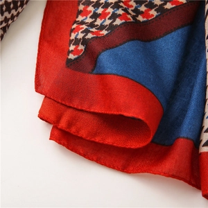 Detail of multi-color patchwork cotton linen scarf with classic houndstooth pattern and edges