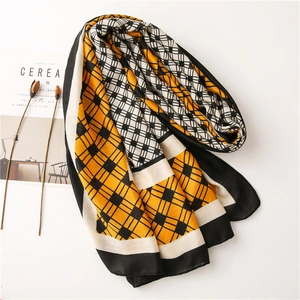 Detail of ginger yellow and black-white plaid cotton linen scarf with fine hem stitching