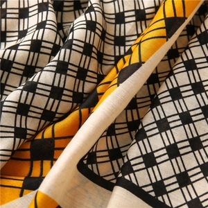 Detailed macro view of woven fabric texture with yellow and black geometric patterns