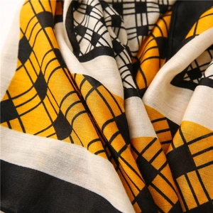 Detailed texture of cotton linen scarf with geometric pattern in yellow and black