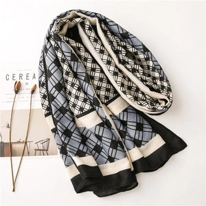 Close-up of three-color geometric checkered scarf texture with elegant lifestyle props