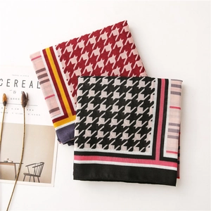 Houndstooth pattern soft cotton linen scarf with contrast stripes on a minimal background