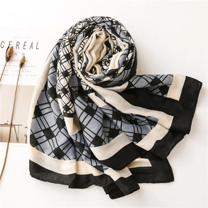 Detailed view of geometric pattern cotton linen scarf with elegant rolled edges