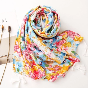 Detailed view of floral cotton scarf with colorful oil painting pattern and white fringe