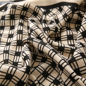 Macro detail of high-quality woven black and white checkered linen feel scarf texture