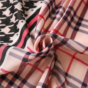 Detailed view of houndstooth and plaid printed linen shawl showing soft fabric texture