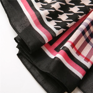 Detailed close-up of houndstooth cotton linen scarf showing soft fabric texture and drape