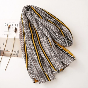 Fashionable long scarf with geometric diamond pattern and stripes in yellow and black