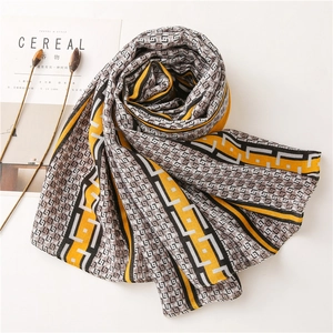 Detail of yellow and black geometric pattern scarf showing soft fabric texture and style