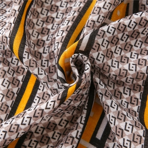 Soft cotton-linen scarf with geometric letter print in yellow, black and grey tones