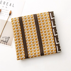 Detail shot of yellow scarf with geometric patterns alongside a lifestyle magazine