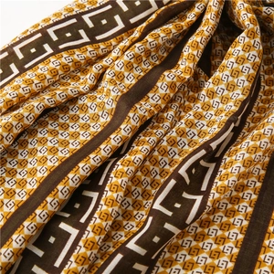 Detail of yellow and brown geometric vintage print on soft cotton linen fabric texture
