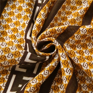 Close-up of geometric pattern fabric with warm mustard yellow and brown diamond weave