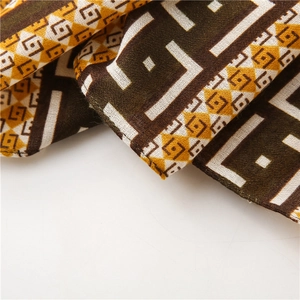 Close-up of geometric pattern on cotton-linen scarf with fine stitching details