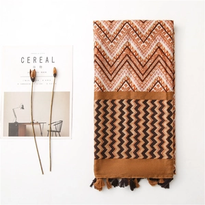 Zigzag pattern cotton linen scarf with tassels displayed with dried flowers and magazine