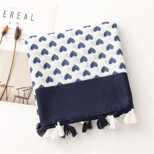 Detail of cotton linen scarf with blue heart prints, spliced edges and fringe tassels