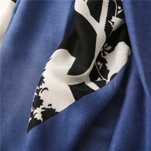 Macro detail of royal blue scarf fabric with elegant monochrome floral leaf patterns