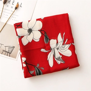 Close-up of floral print scarf in red with soft cotton-linen texture and clear patterns