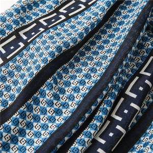 Detailed macro view of geometric print fabric with intricate patterns and light texture