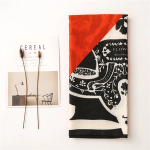 Detail of red and black graffiti pattern scarf with floral motifs and floral accents