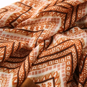Close-up of bohemian geometric wavy pattern and texture on soft cotton linen scarf