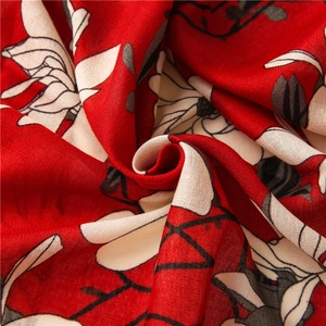 Detail of red floral cotton-linen scarf showing the woven texture and white flower pattern