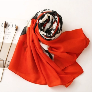 Detail of red and black graffiti pattern scarf with soft chiffon fabric texture