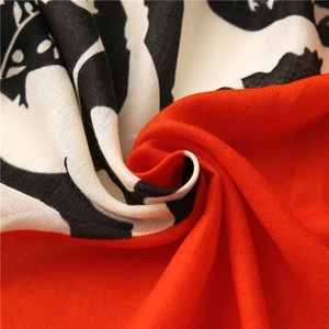Detailed macro shot of abstract geometric patterns on red and black chiffon scarf fabric