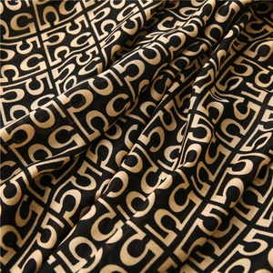 Detail of the soft cotton-linen scarf with yellow letter C and number 5 patterns