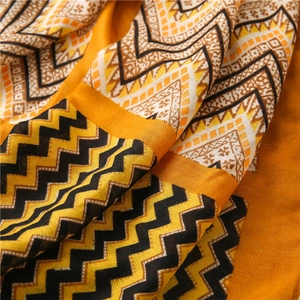 Detail of soft fabric with orange chevron waves and geometric ethnic patterns