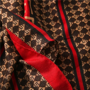 Detailed view of geometric rhombus pattern and fine textile texture on the scarf shawl