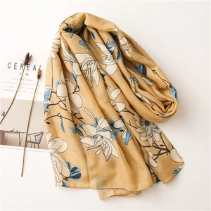 Detail of ginger floral scarf with soft cotton-linen texture next to Cereal magazine